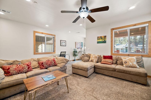 carpeted living room with ceiling fan