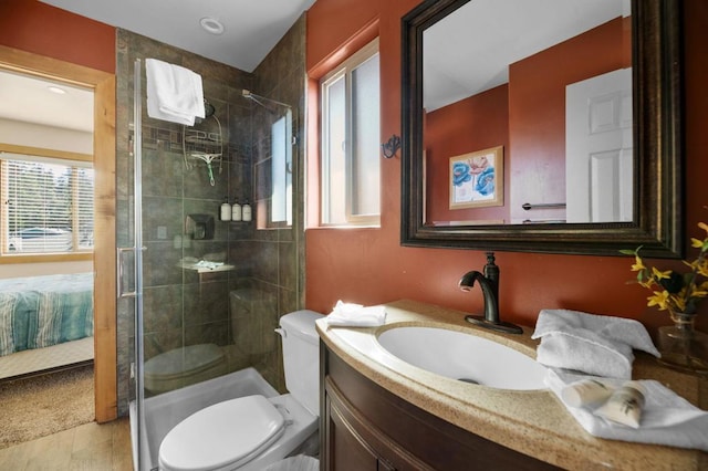 bathroom featuring walk in shower, tile patterned floors, vanity, and toilet