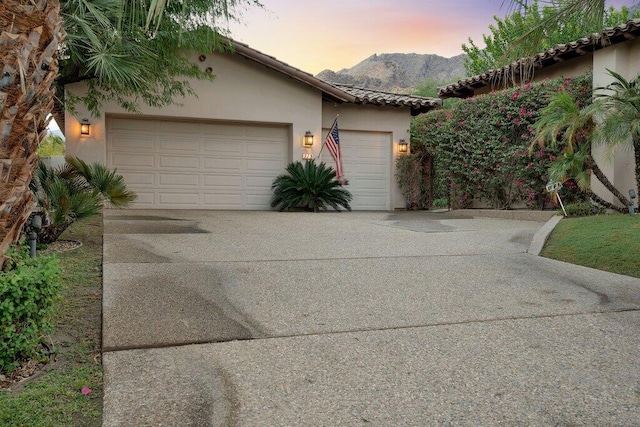 view of front of home with a mountain view and a garage