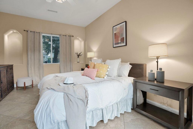 bedroom with ceiling fan and light tile patterned floors