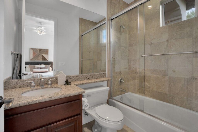 full bathroom featuring shower / bath combination with glass door, vanity, toilet, and ceiling fan