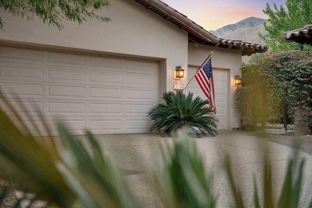 exterior space with a mountain view and a garage