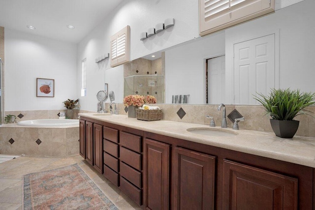 bathroom with tile patterned flooring, vanity, and plus walk in shower