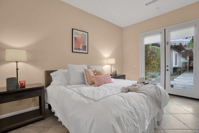 bedroom with access to outside, french doors, and light tile patterned floors