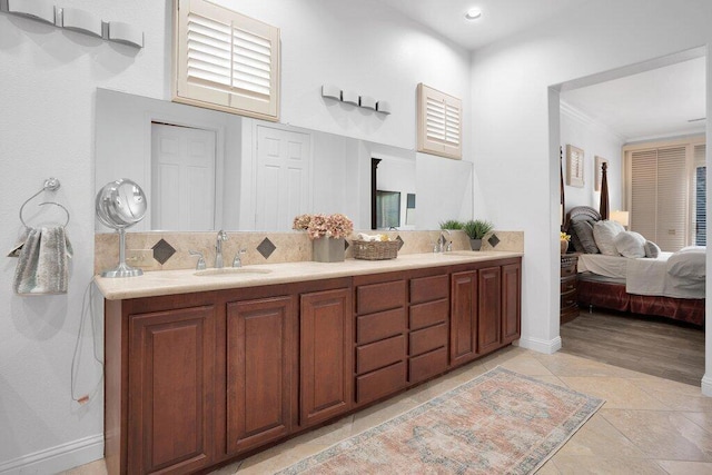 bathroom featuring decorative backsplash, vanity, tile patterned floors, and ornamental molding