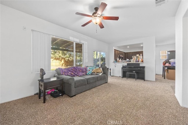 living room with ceiling fan and light carpet