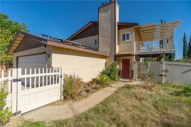 exterior space featuring a balcony and a garage