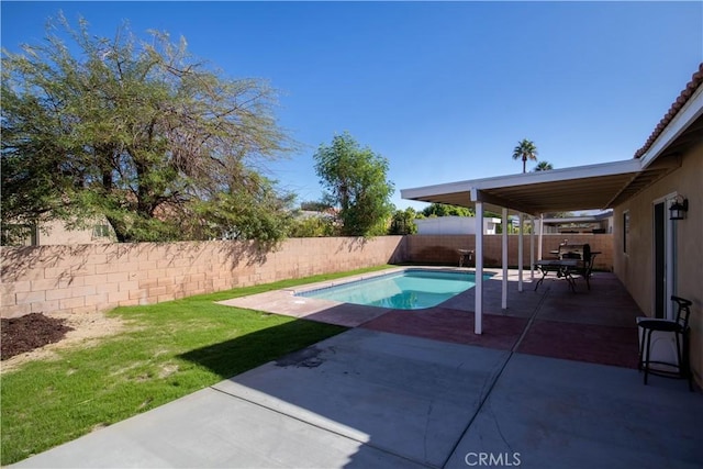 view of swimming pool featuring a patio and a lawn