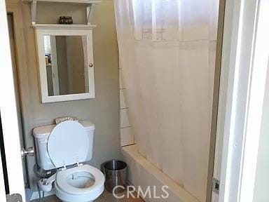 bathroom featuring toilet and a shower