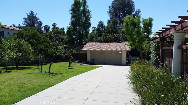 exterior space with a garage, an outbuilding, and a lawn