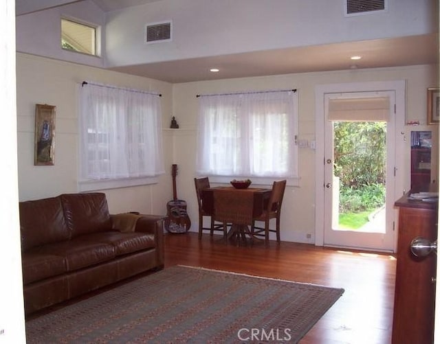 living room featuring dark hardwood / wood-style flooring and lofted ceiling