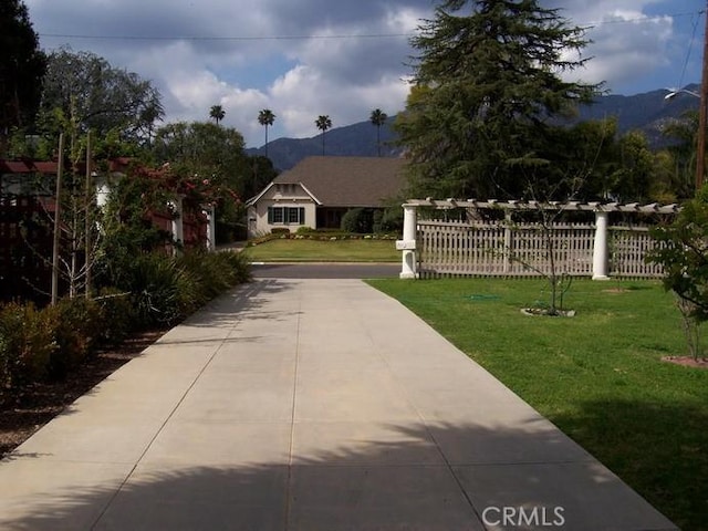 exterior space with a lawn and a mountain view