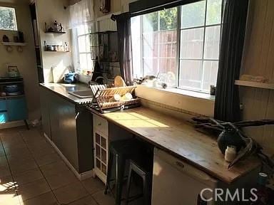 kitchen featuring dark tile patterned flooring