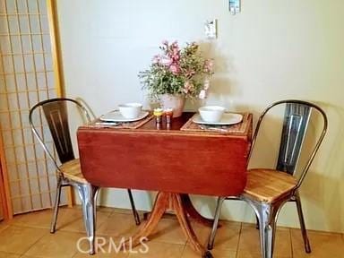 dining area with light tile patterned floors