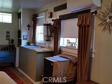 kitchen featuring sink and a wall mounted air conditioner