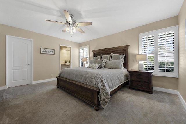 bedroom featuring multiple windows, ceiling fan, light colored carpet, and ensuite bathroom