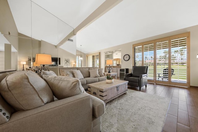 living room featuring beam ceiling, dark hardwood / wood-style flooring, beverage cooler, and high vaulted ceiling