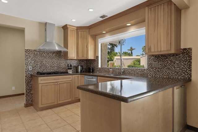 kitchen with backsplash, kitchen peninsula, light brown cabinets, and wall chimney exhaust hood