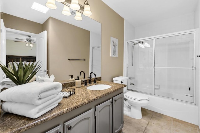 full bathroom with ceiling fan, combined bath / shower with glass door, tile patterned floors, toilet, and vanity