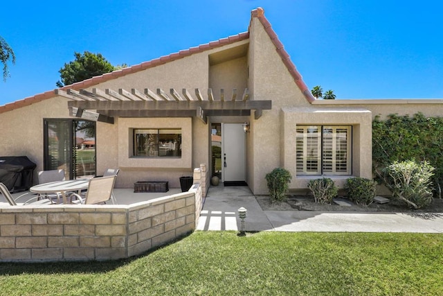 rear view of house with a pergola, a yard, and a patio area