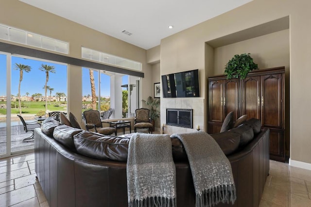 living room with a tiled fireplace