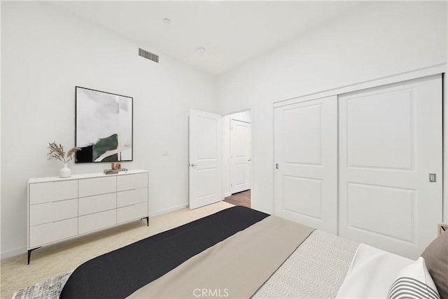 bedroom featuring a closet and light colored carpet