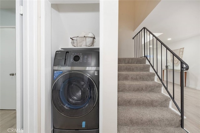 laundry area with hardwood / wood-style flooring and washer / clothes dryer