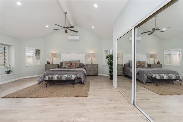 bedroom with ceiling fan, a wall unit AC, beamed ceiling, and light hardwood / wood-style floors