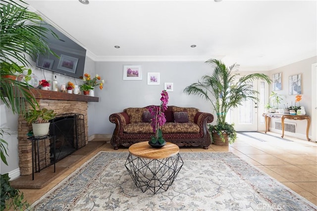 tiled living room featuring a stone fireplace and ornamental molding