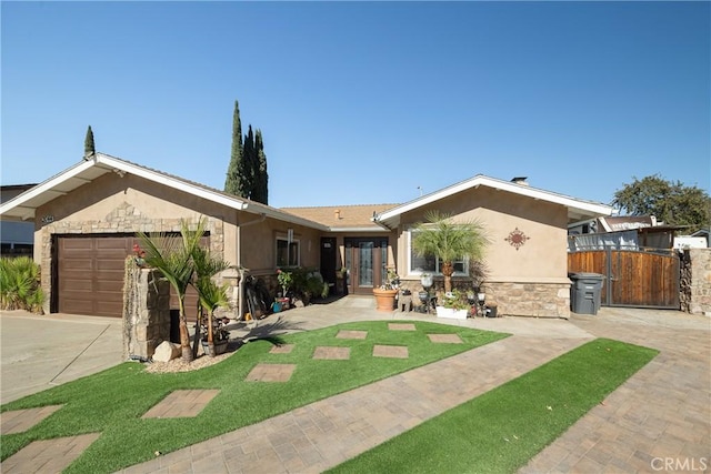 ranch-style house featuring a front yard and a garage