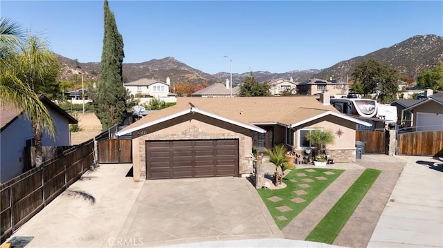 ranch-style home with a mountain view and a garage