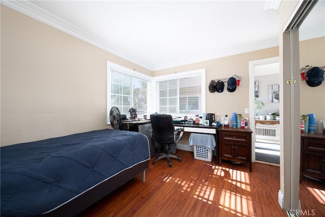 bedroom featuring dark hardwood / wood-style floors and ornamental molding