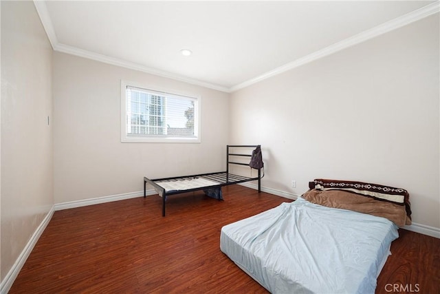 bedroom with dark hardwood / wood-style floors and ornamental molding