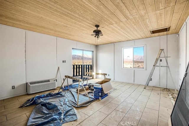 misc room featuring wooden ceiling and a wall unit AC