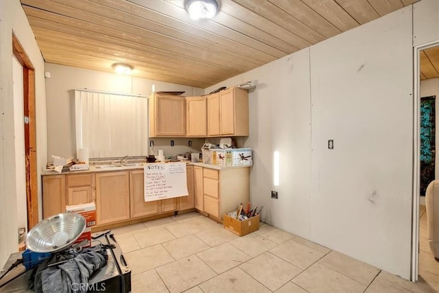 kitchen featuring light tile patterned floors, wood ceiling, sink, and light brown cabinetry