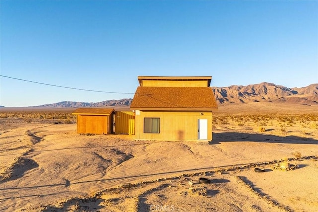 back of property with a mountain view