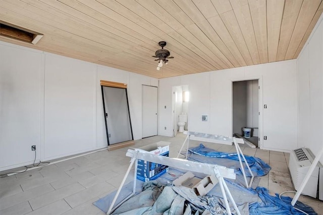 interior space with ceiling fan