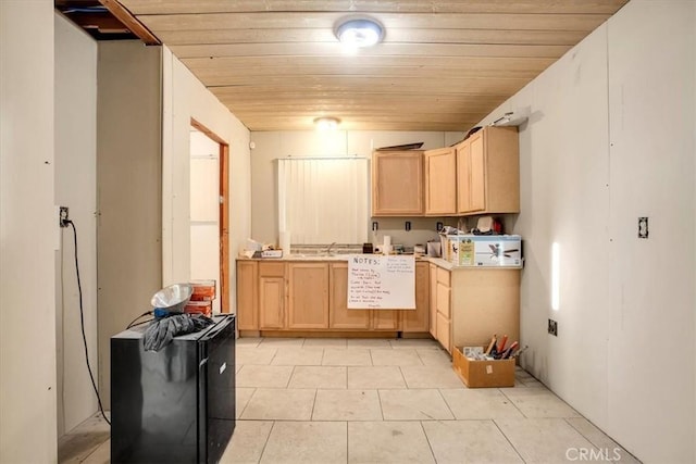 kitchen featuring light brown cabinets, light tile patterned floors, wooden ceiling, and sink