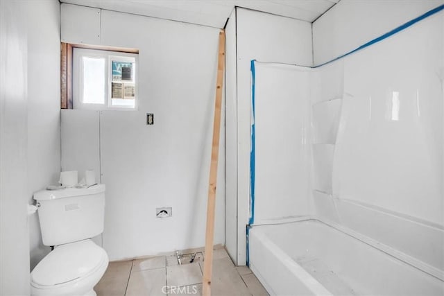 bathroom with tile patterned flooring, toilet, and tub / shower combination