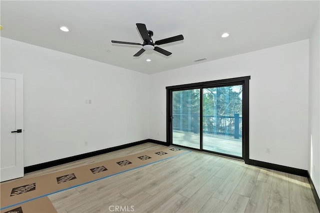 spare room featuring ceiling fan and light hardwood / wood-style floors