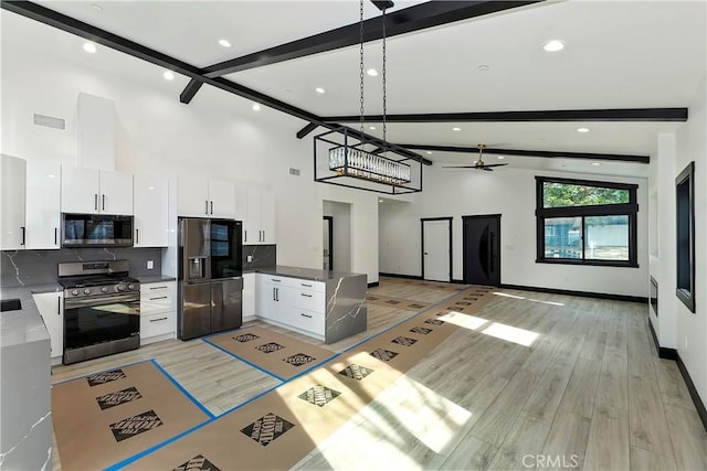 kitchen featuring pendant lighting, decorative backsplash, beamed ceiling, white cabinetry, and stainless steel appliances