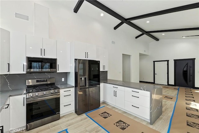 kitchen with backsplash, beam ceiling, white cabinetry, light hardwood / wood-style flooring, and stainless steel appliances