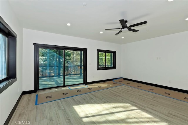 spare room with ceiling fan and light hardwood / wood-style floors