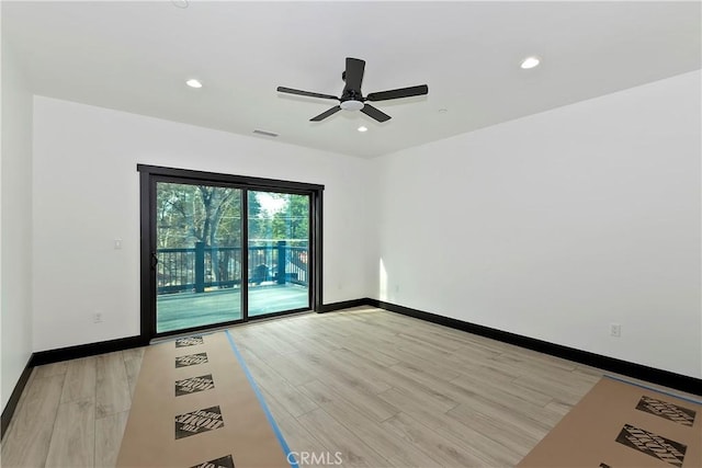 empty room with ceiling fan and light hardwood / wood-style floors