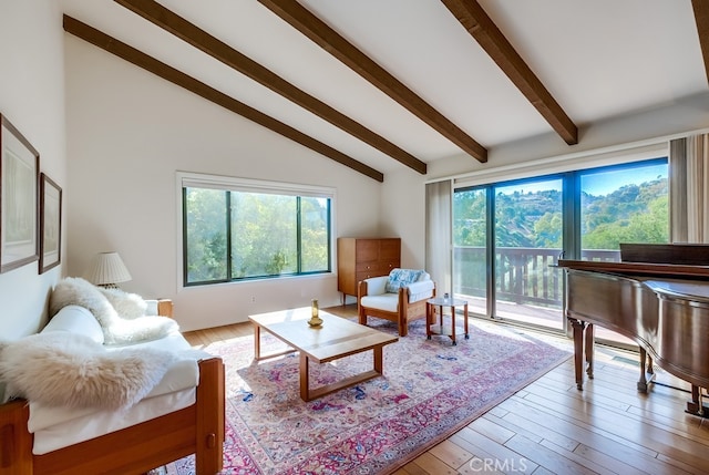 living room with beamed ceiling, light hardwood / wood-style floors, and high vaulted ceiling