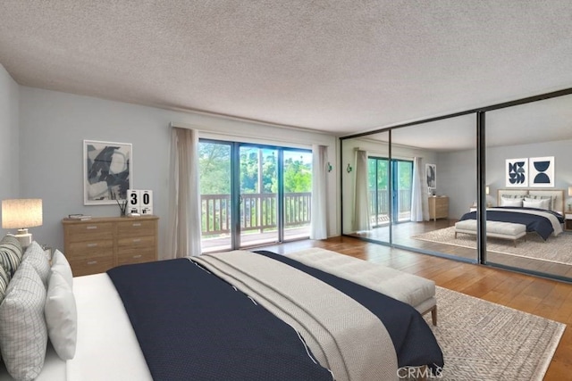 bedroom featuring hardwood / wood-style floors, access to exterior, a textured ceiling, and a closet