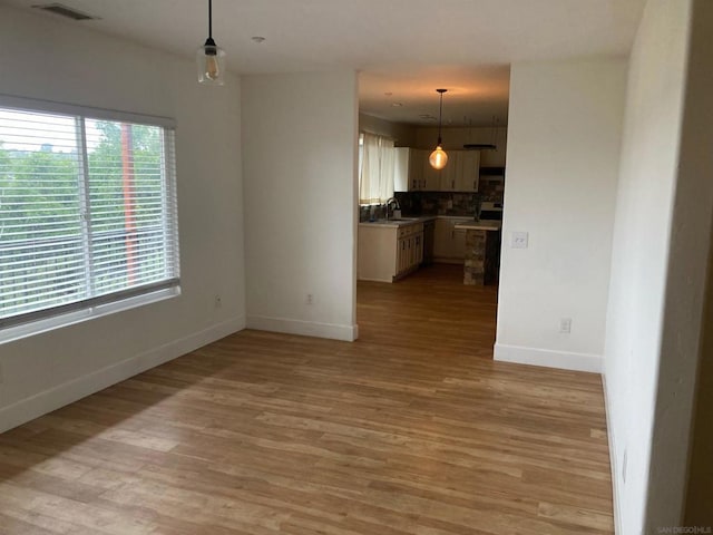 interior space with sink and light hardwood / wood-style flooring