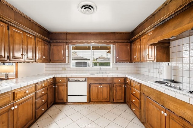 kitchen with tile countertops, decorative backsplash, sink, white appliances, and light tile patterned flooring