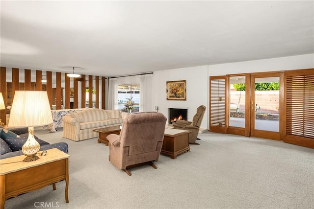 living room featuring light carpet and a healthy amount of sunlight