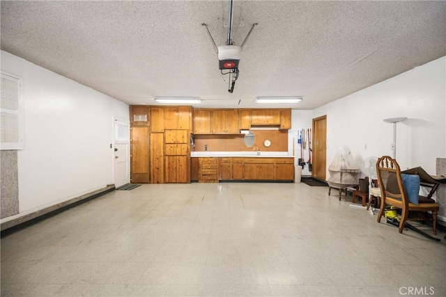 garage featuring sink and a garage door opener